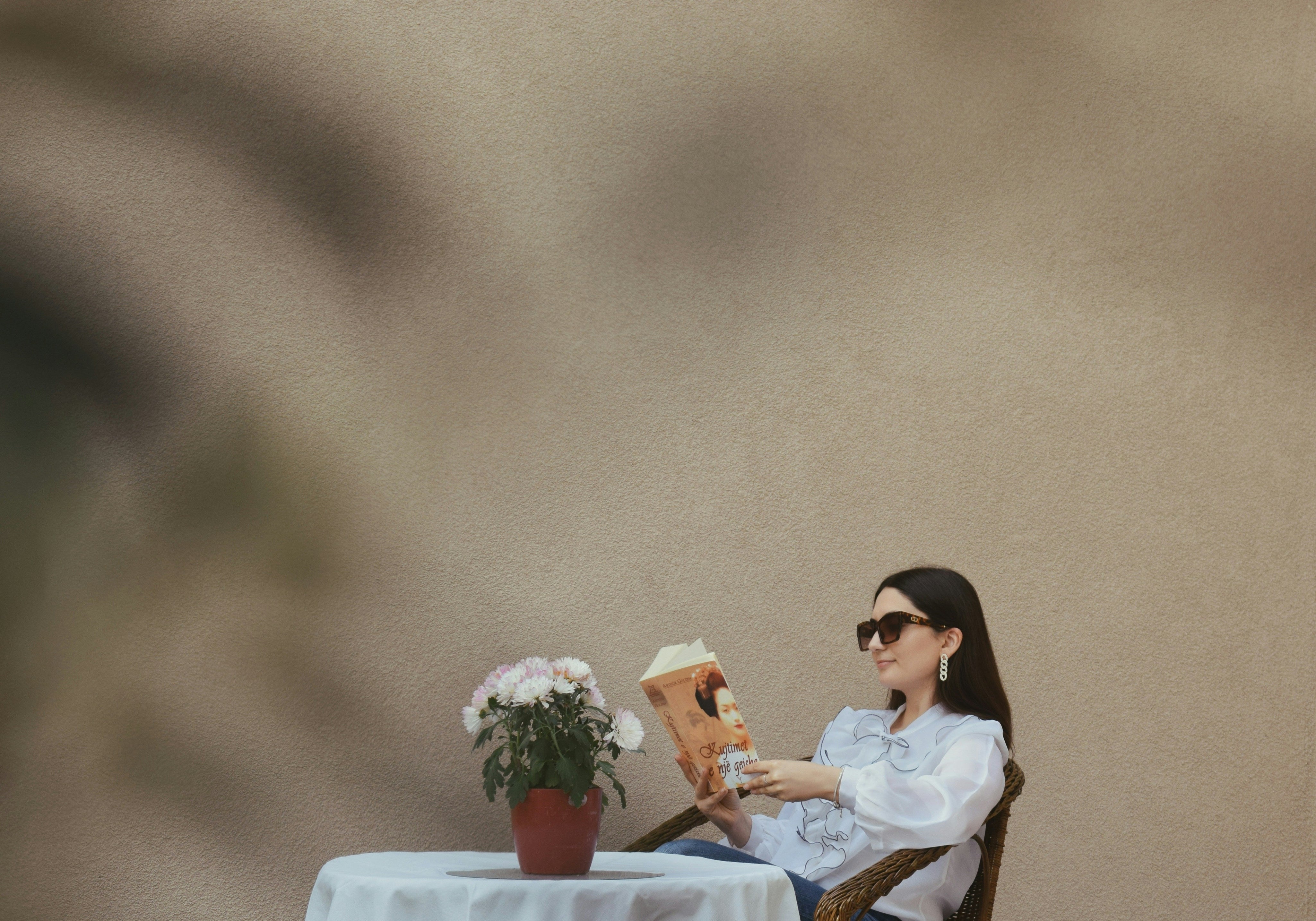 Cozy scene of a stylish woman reading on a patio