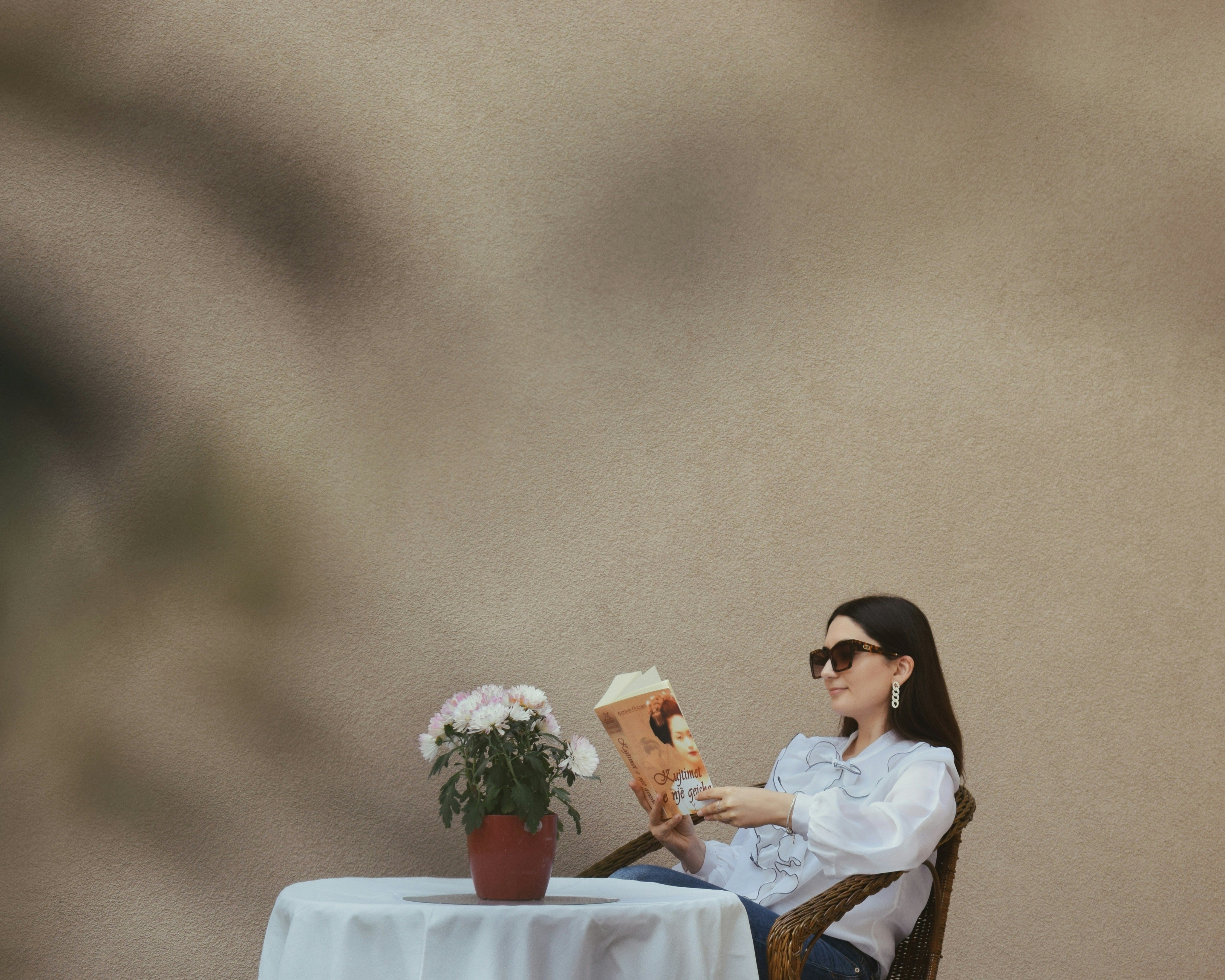 Cozy scene of a stylish woman reading on a patio