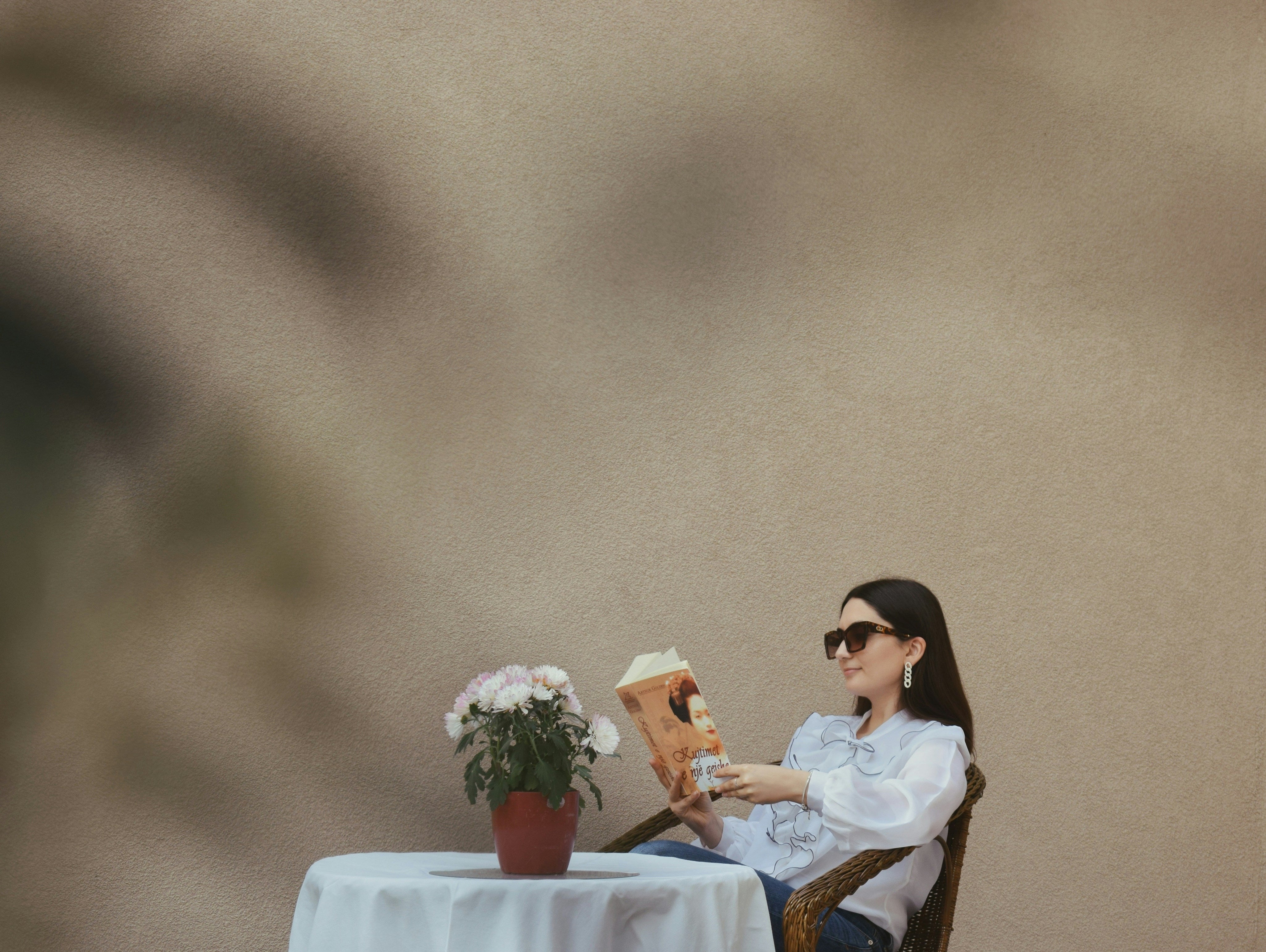 Cozy scene of a stylish woman reading on a patio